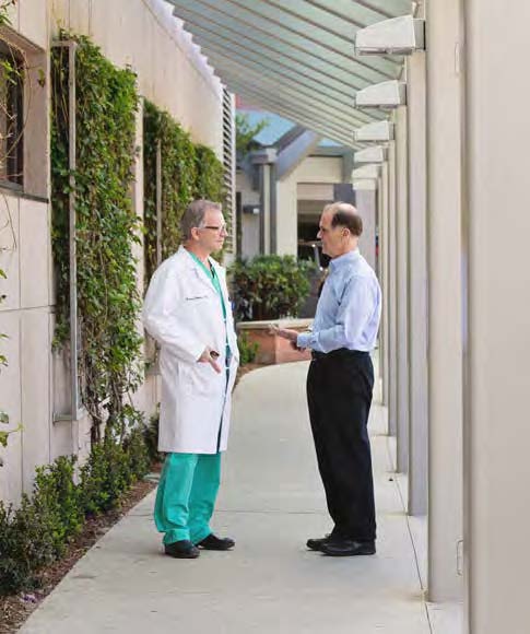 Dr. Greg Fontana confers with his patient, Steve Hanke, at Los Robles Hospital.